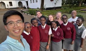 Alan Woo (left) takes a selfie with Peter Jutras, Alyssa Cagle, Emily Gertsch, Greg Satterthwaite, and several students from the Moi Girls School. 