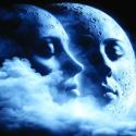 Two faces within the moon surrounded by clouds and dark blue sky.