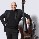 Milton Masciadri, professor of double bass, in front of a white background